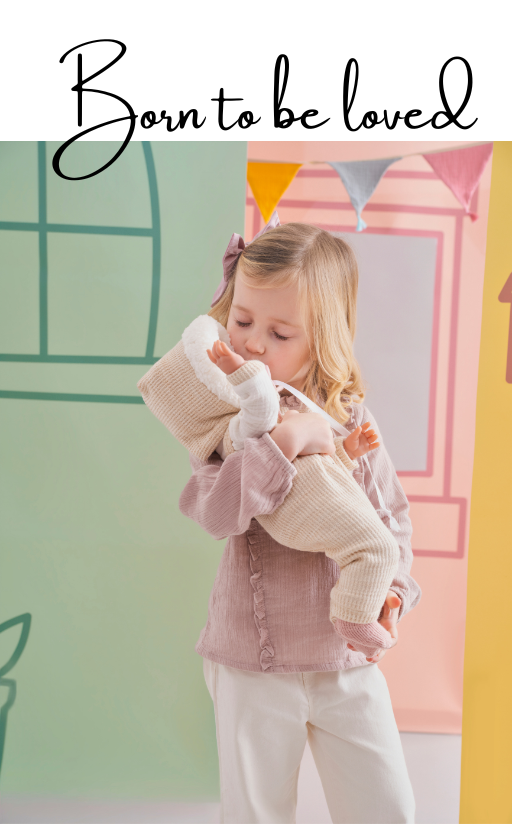 Child holding a doll with colorful background and text 'Born to be loved'.